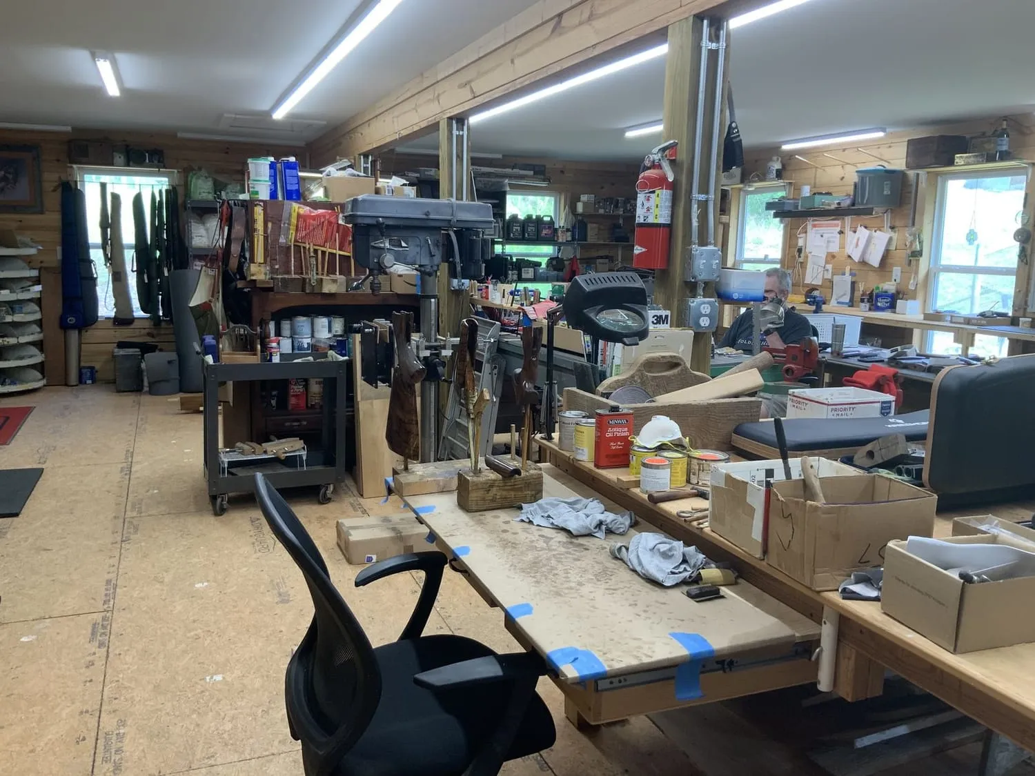 Long view down the shop, benches either side and windows at the far end